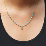 Michal Golan Tiny Turquoise Hamsa Necklace Being Worn