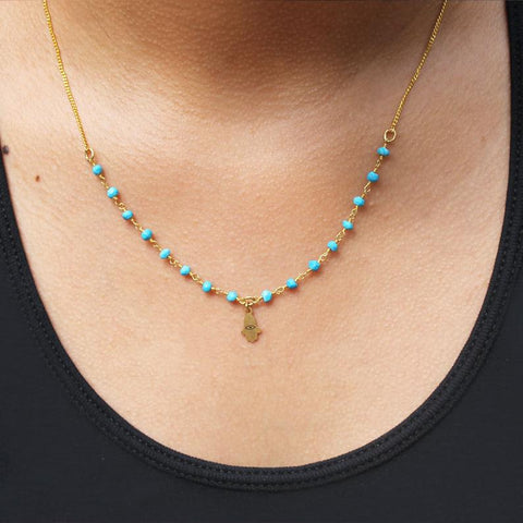  Michal Golan Tiny Turquoise Hamsa Necklace Being Worn